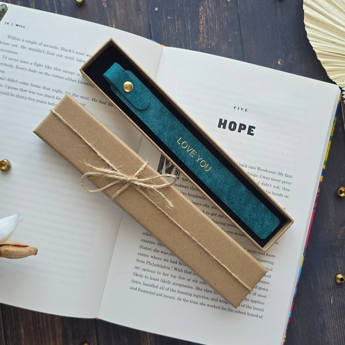 Handmade leather bookmark inside a book