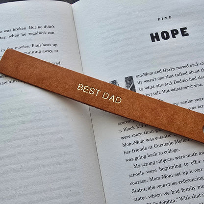 Personalised leather bookmark inside a book