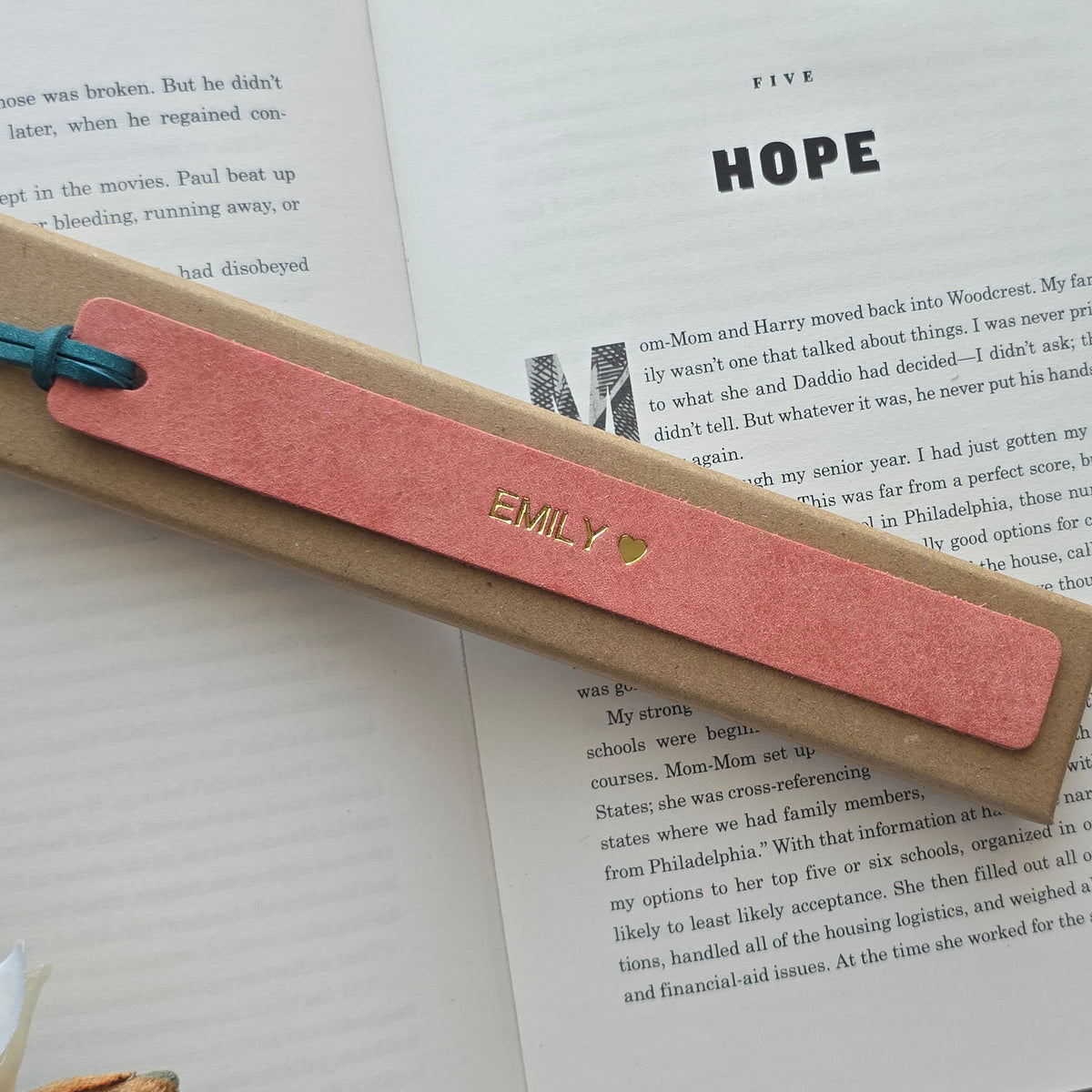 Personalised leather bookmark inside a book