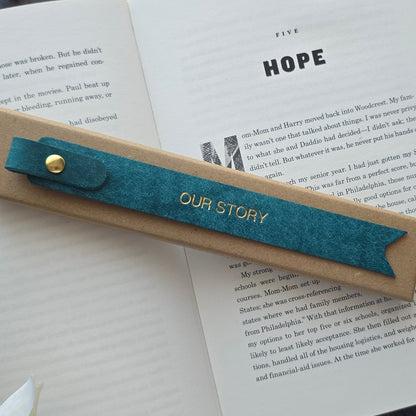 Navy leather bookmark personalised with OUR STORY