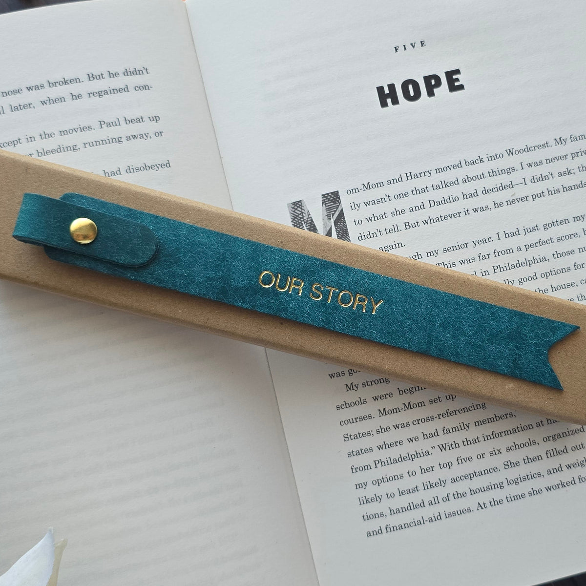 Handmade personalised leather bookmark in a book
