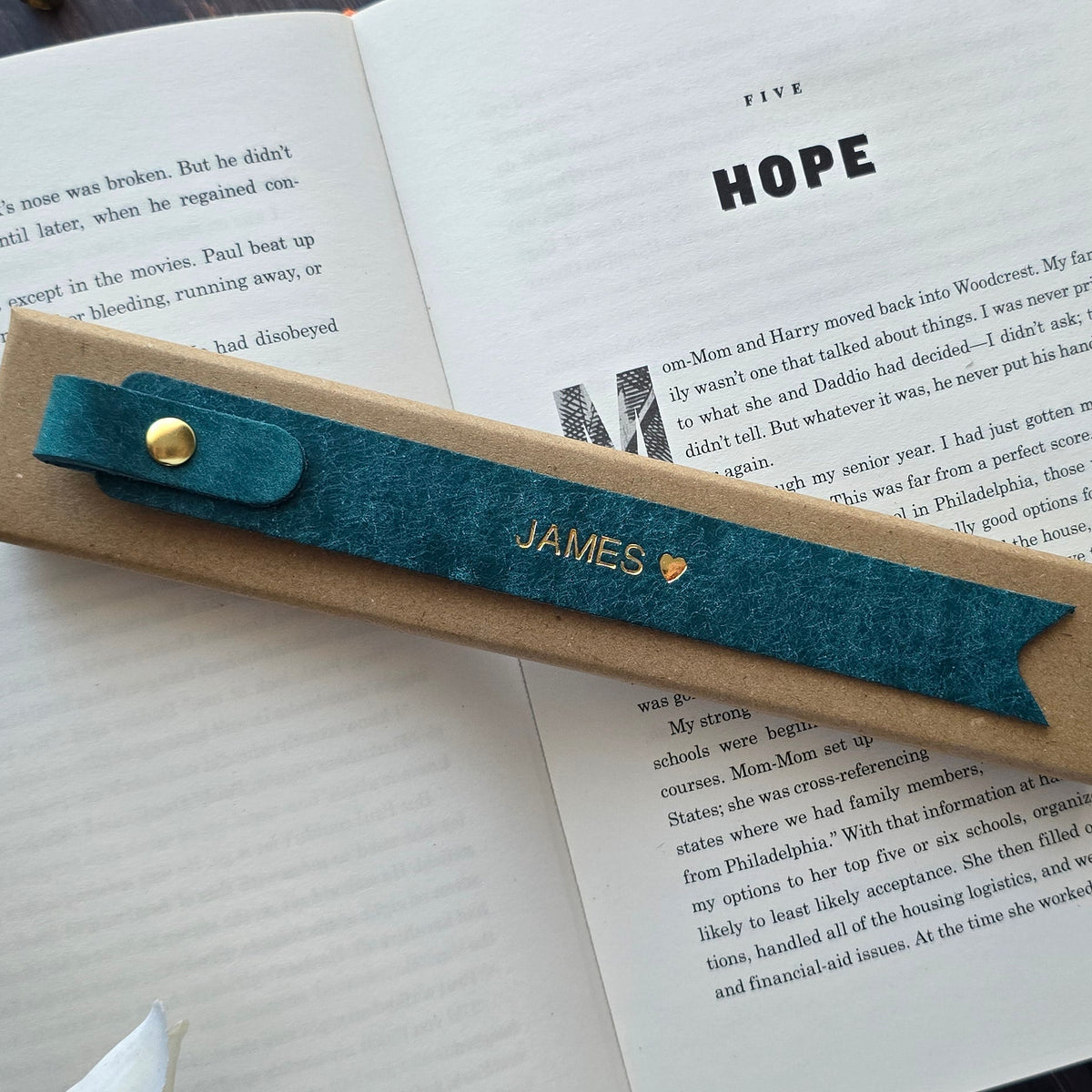 Handmade leather bookmark inside a book