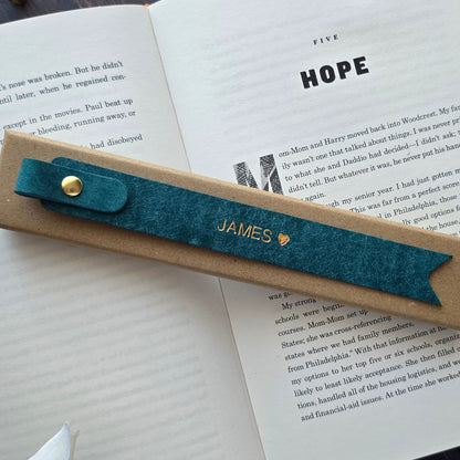 Handmade leather bookmark inside a book